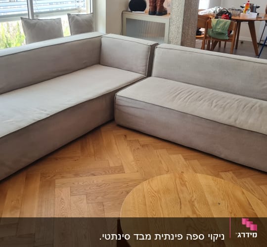 ספה אפורה בחדר מגורים עם רצפת עץ